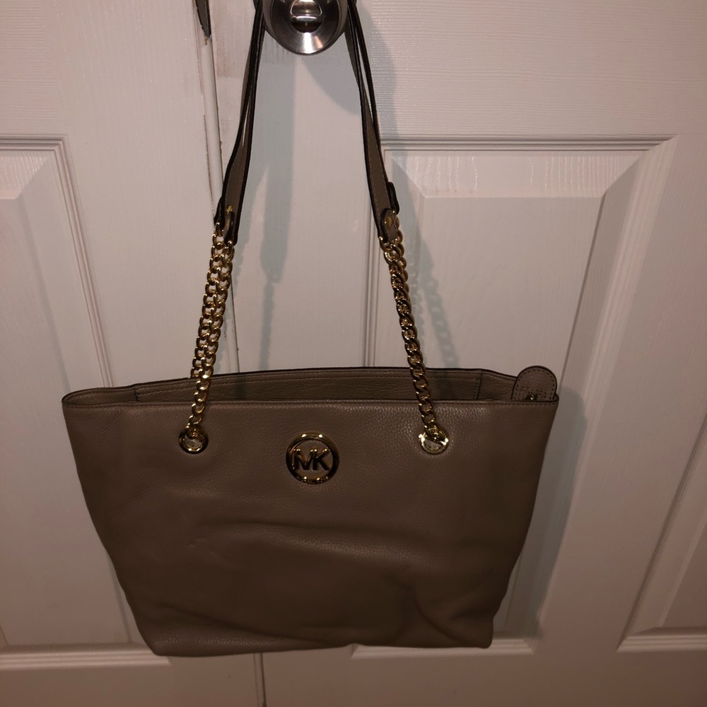Selling A brand new MK purse in a cream color way with gold accents.